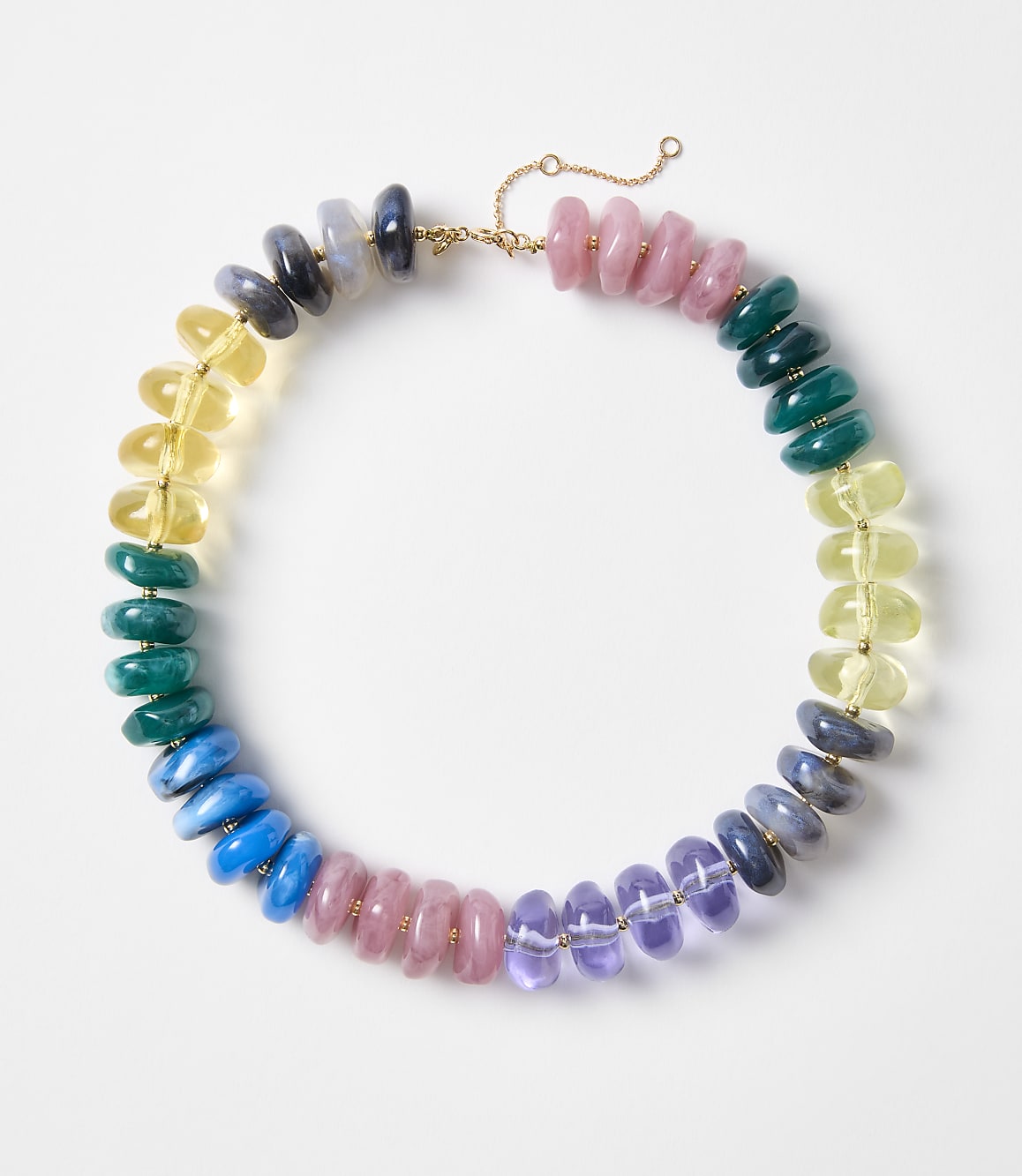 A colorful beaded necklace with pink, blue, green, yellow, and purple stones is laid out on a white background.