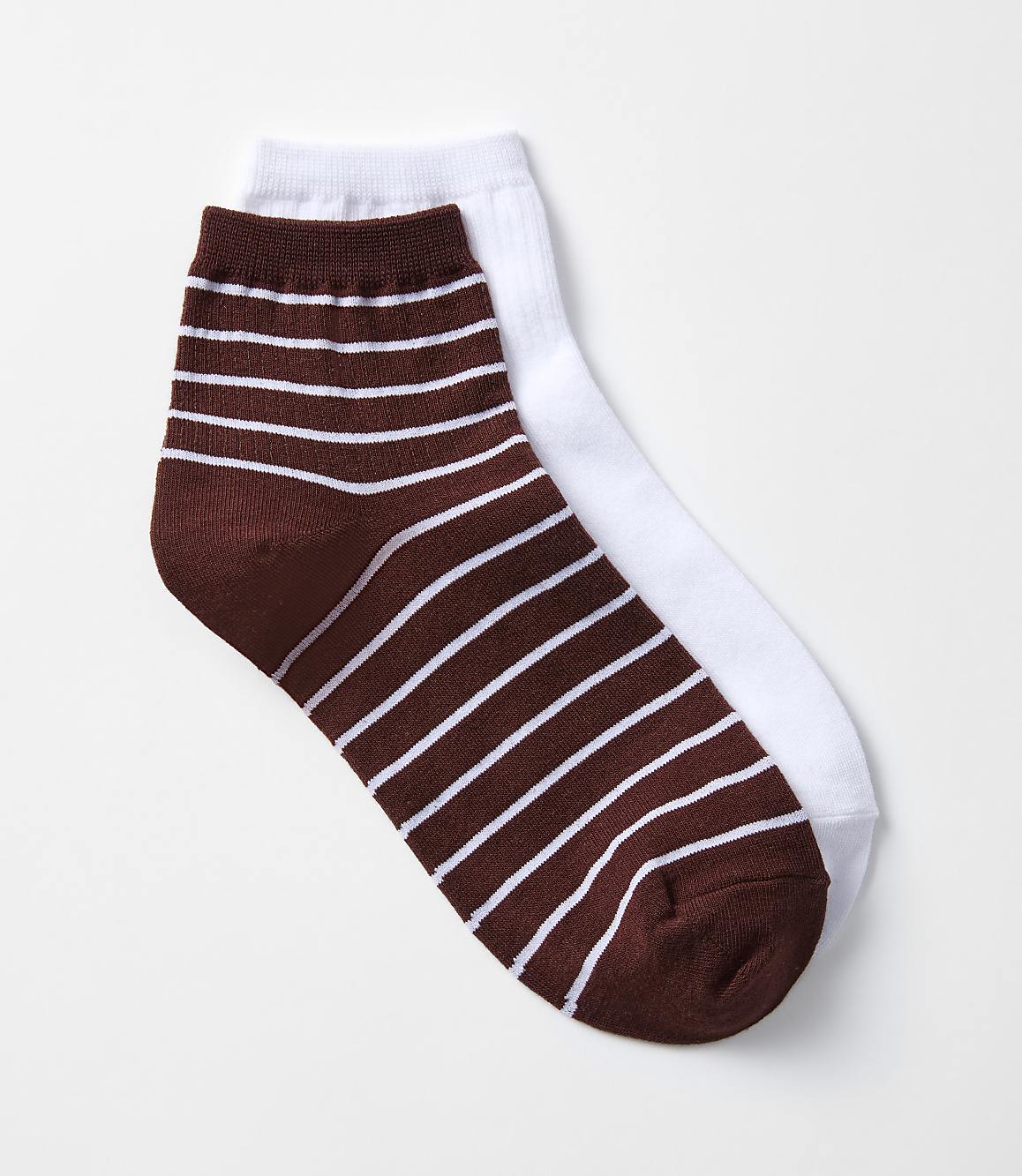 A pair of ankle socks, one striped brown and white in the foreground, rests on a plain white sock in the background against a white backdrop.