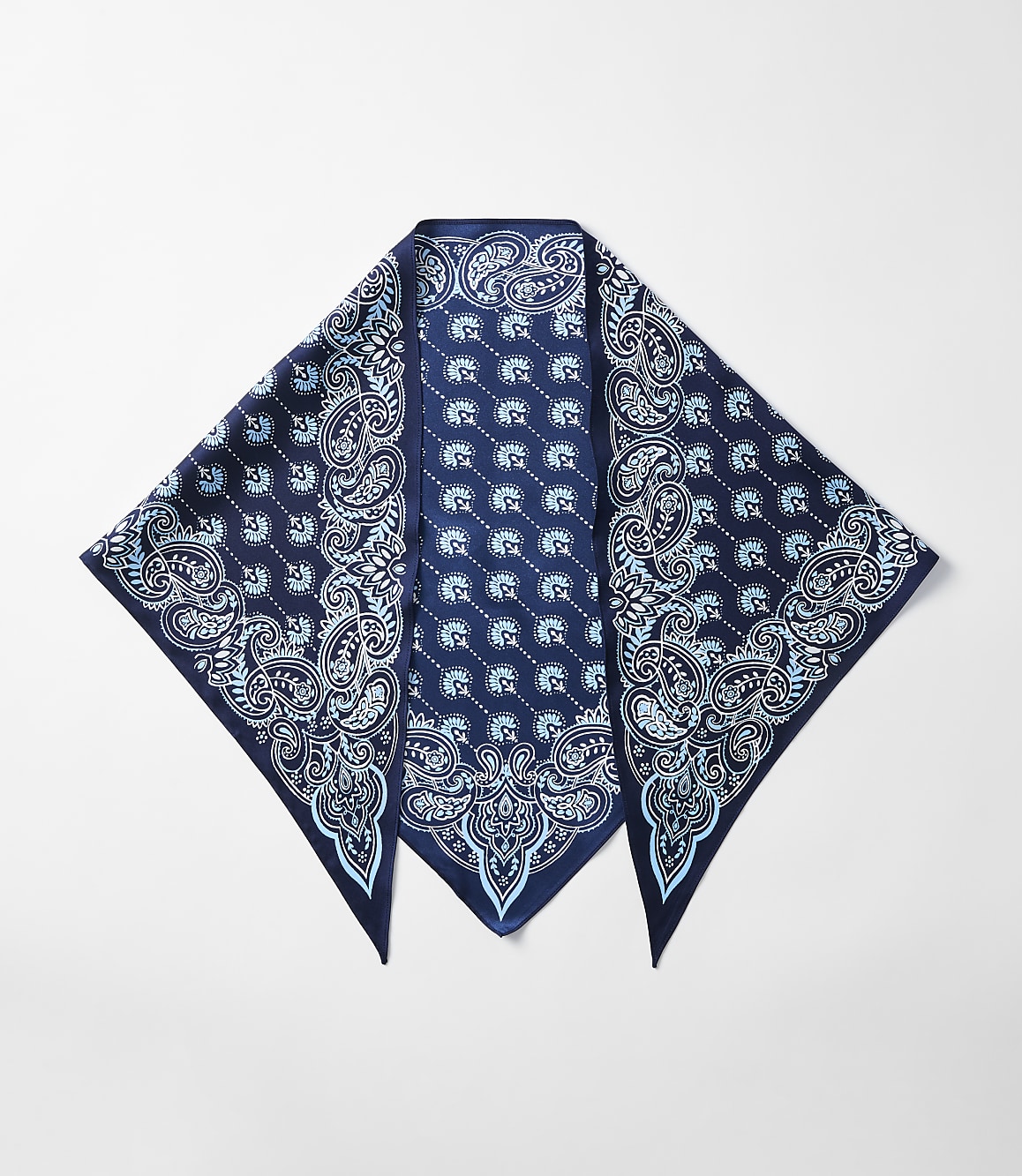 A dark blue bandana with a light blue paisley pattern is laid out flat against a plain white background.