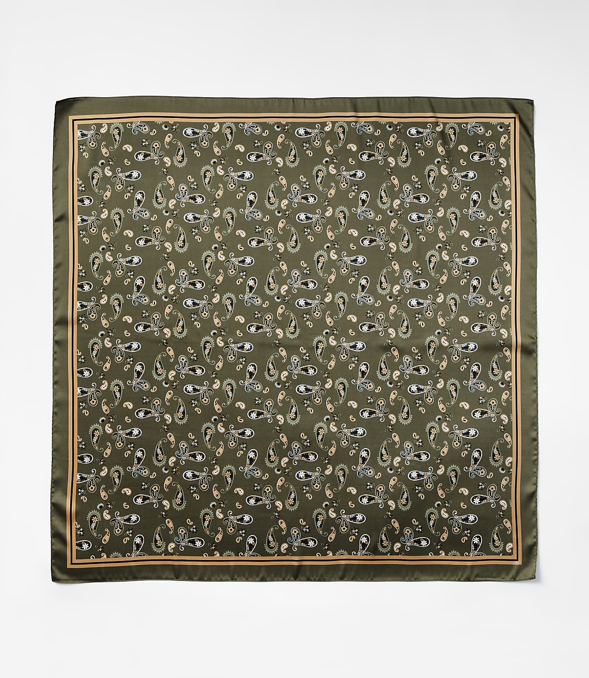 A square silk scarf with a repeating paisley pattern in shades of green, cream, and peach is laid flat against a plain white background.