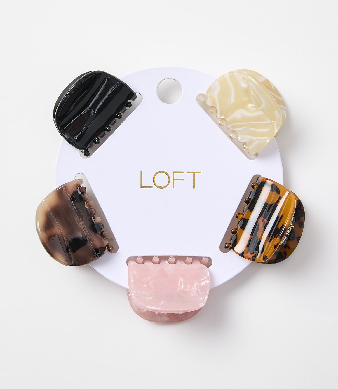 Five colorful claw clips are arranged in a circle on a white card with the "LOFT" logo, against a plain white background.