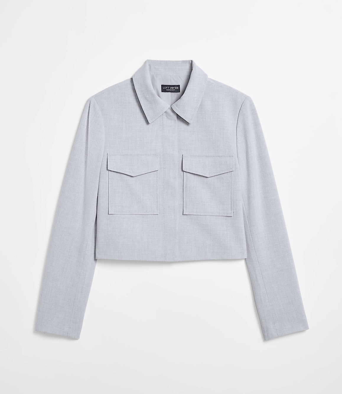 A light blue cropped jacket with two chest pockets is displayed against a plain white background.