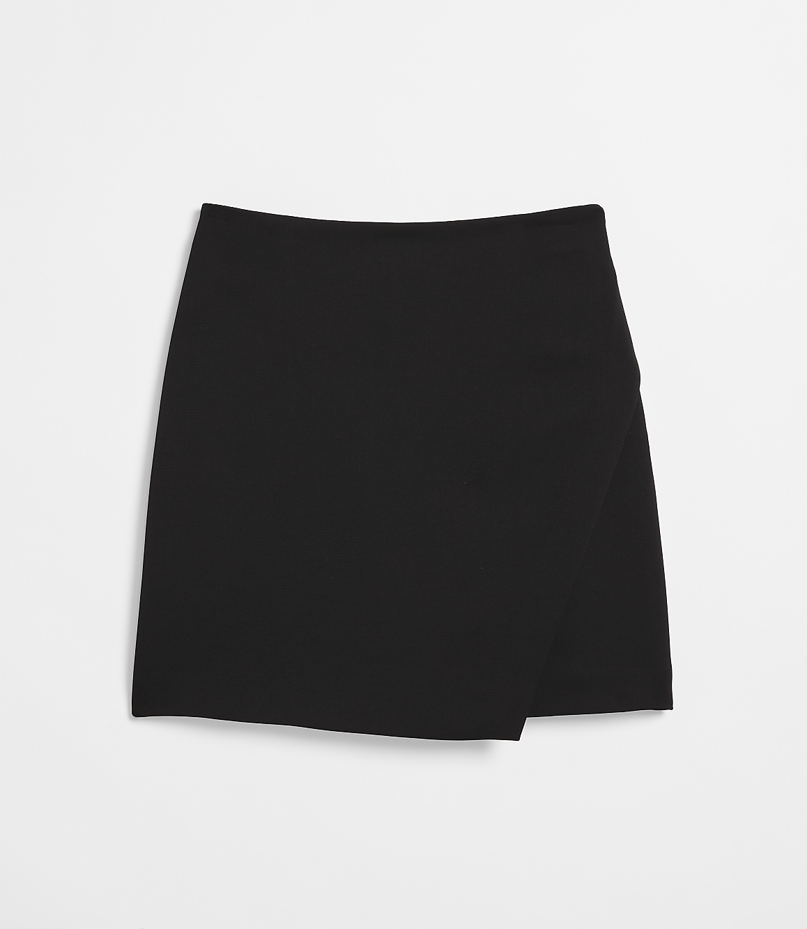 A black asymmetrical skirt lies flat against a white background.