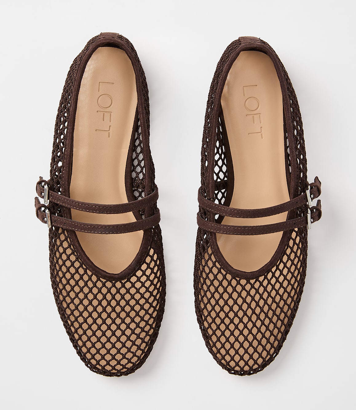 A pair of brown mesh ballet flats with double buckle straps rests on a plain white background.