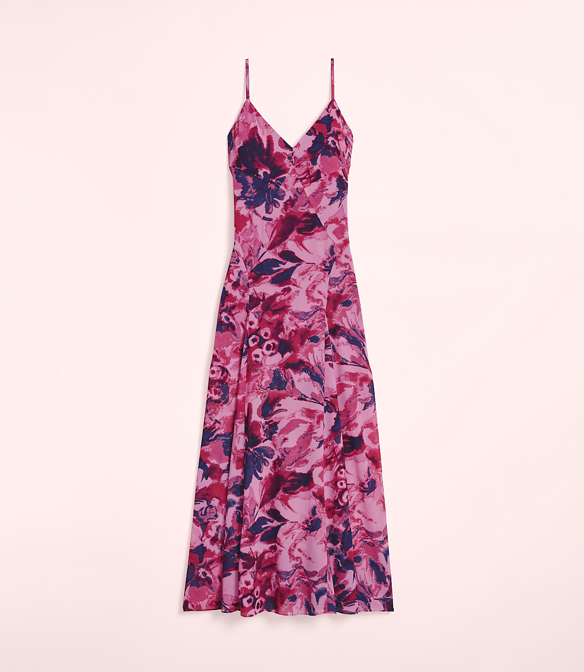 A pink floral dress with spaghetti straps is displayed against a soft pink background.