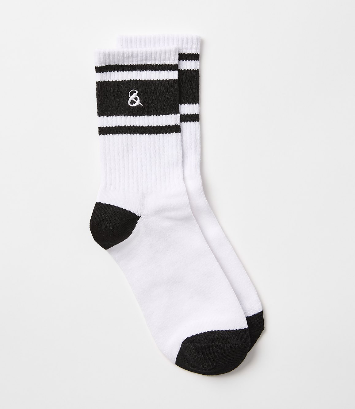 A pair of white crew socks with black stripes and an ampersand logo are laid out against a plain white background.