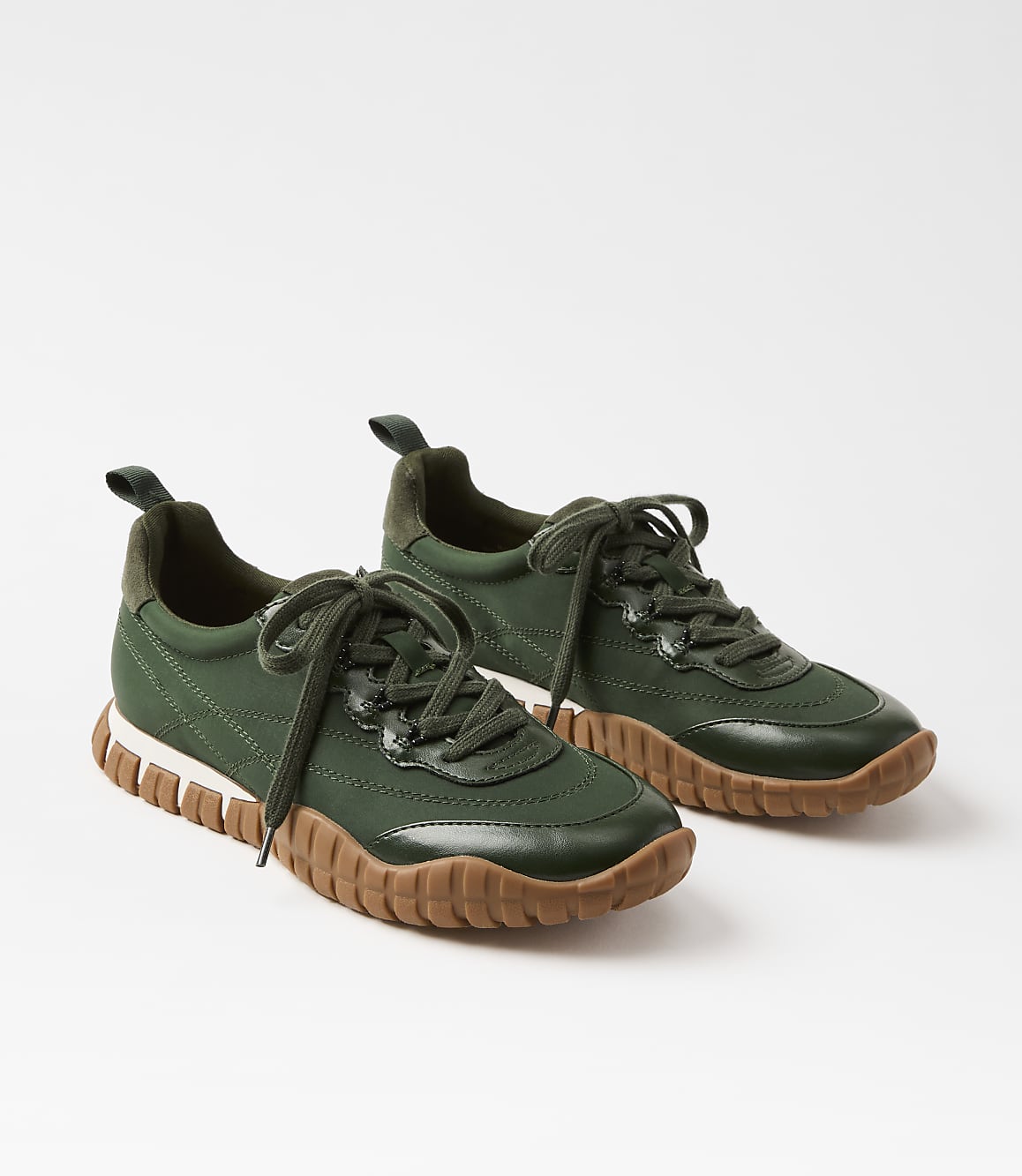 A pair of green sneakers with brown soles rests on a white background.
