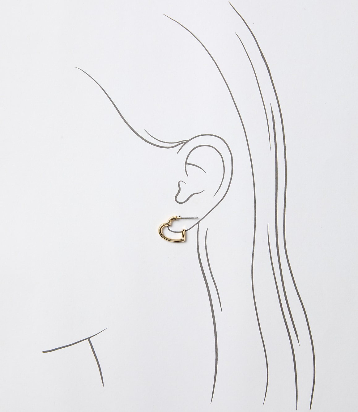 A delicate gold heart-shaped earring adorns an ear, outlined against a simple, light background.