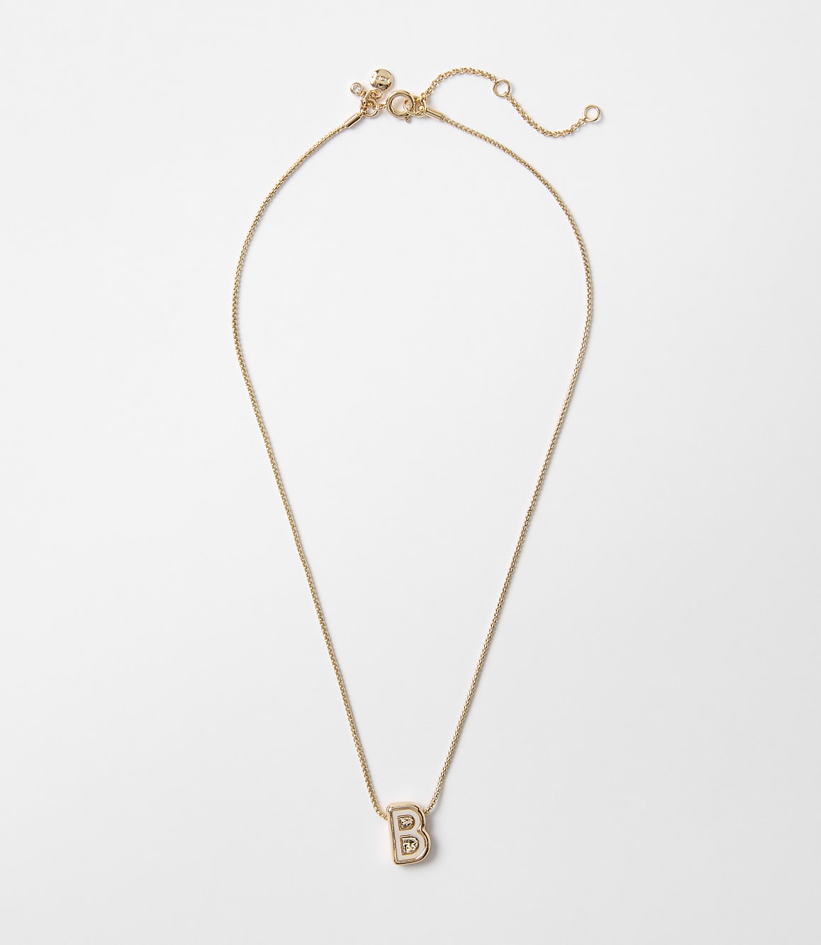 A rose gold necklace with a block letter "B" pendant hangs against a plain white background.