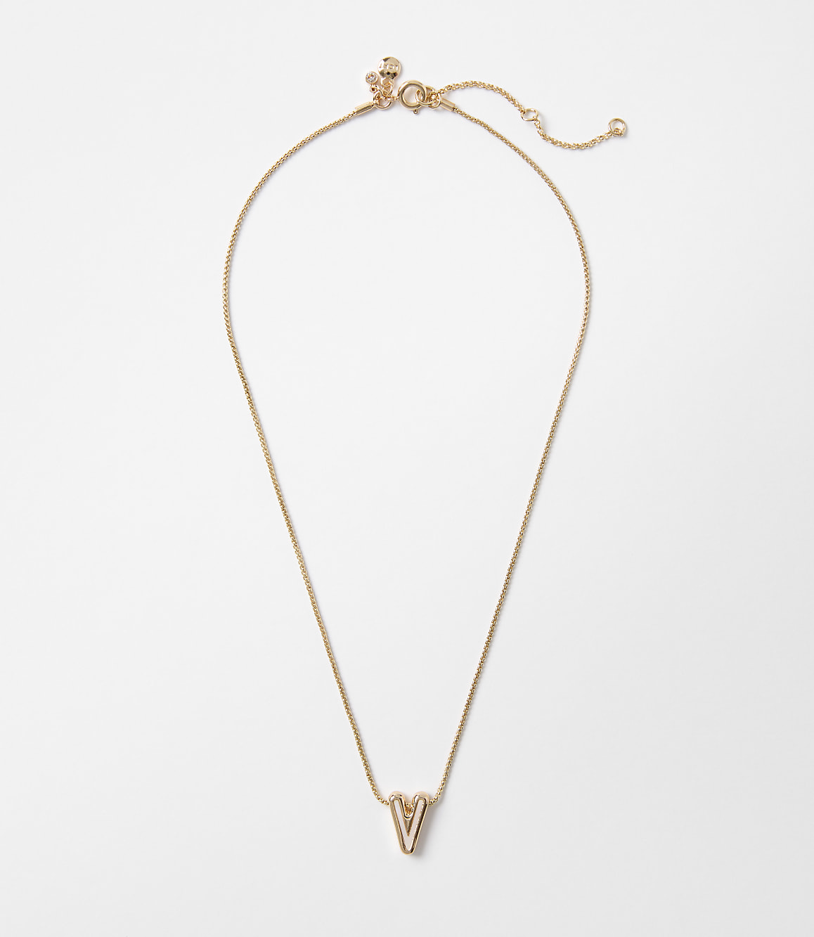 A delicate gold necklace with a "V" pendant hangs against a plain white background.