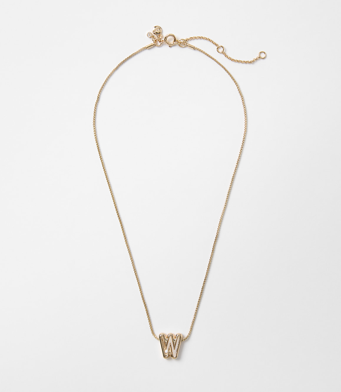 A delicate rose gold necklace with a "W" charm hangs against a plain white background.