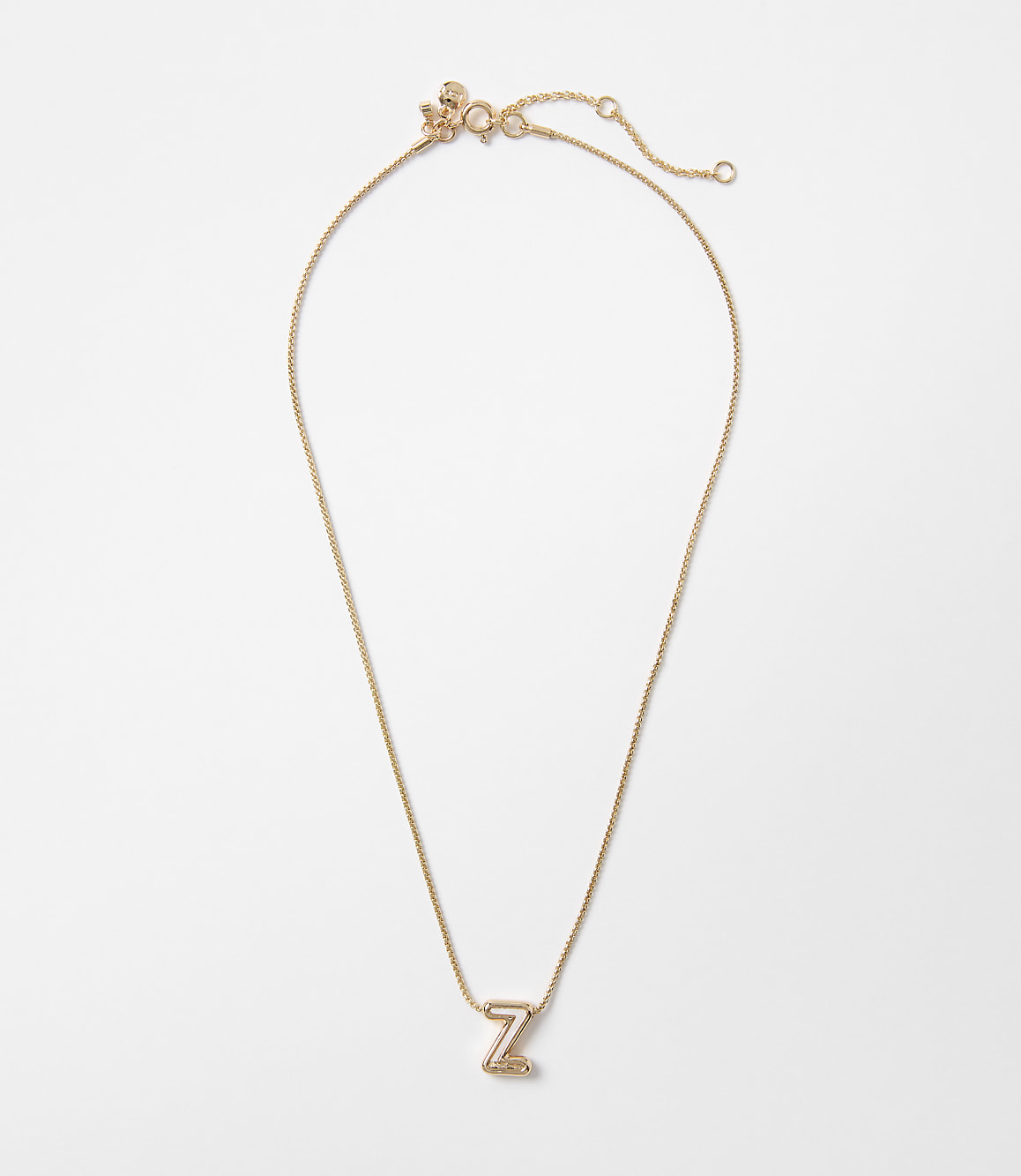 A delicate rose gold necklace with a letter "Z" pendant rests on a plain white background.