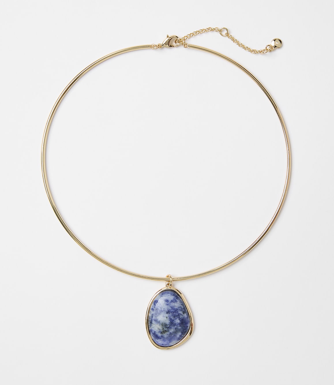 A gold choker necklace with a blue and white marbled stone pendant hangs against a plain white background.