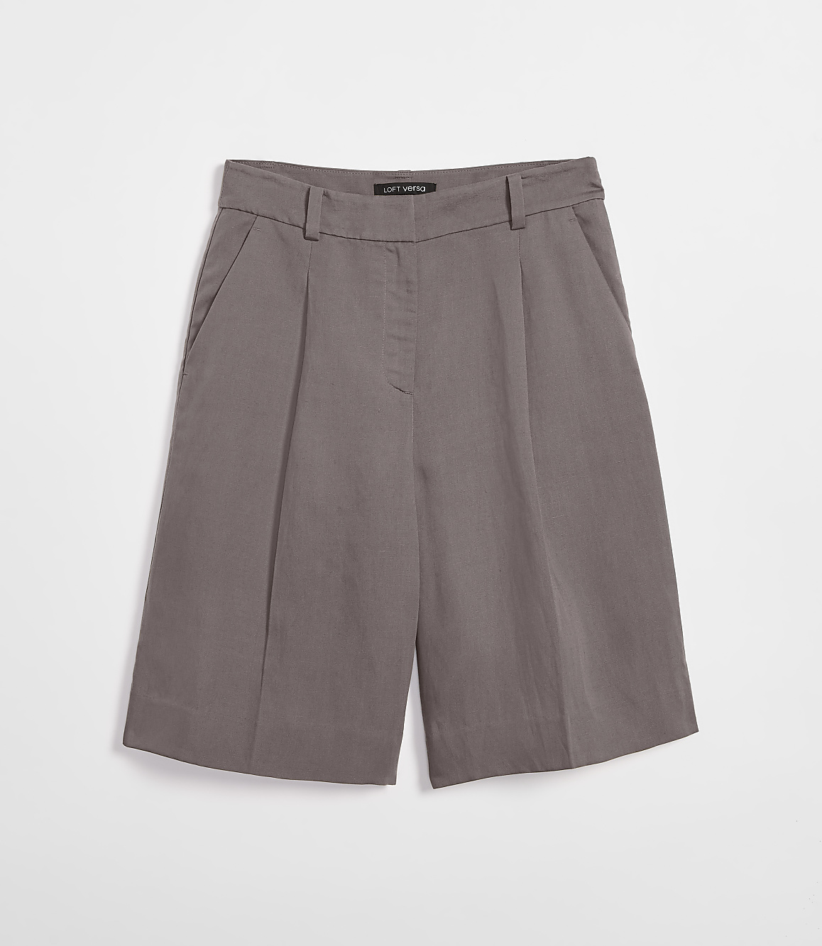 A pair of taupe culottes with pleats and pockets are laid flat against a plain white background.
