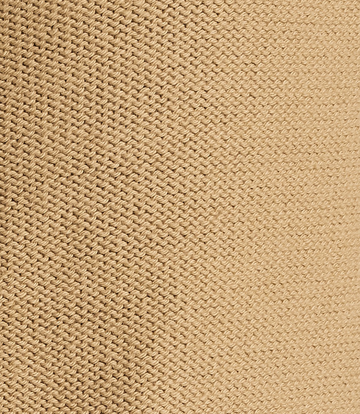 A close-up view of a beige knitted fabric fills the frame, with the texture of the stitches clearly visible throughout.