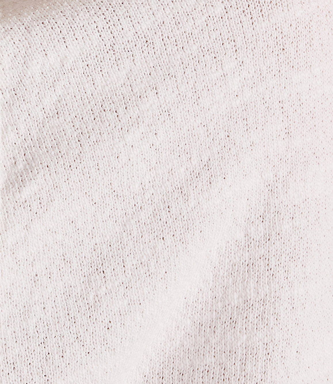 A close-up of a textured, light-colored fabric fills the frame, with subtle shadows and folds creating depth.