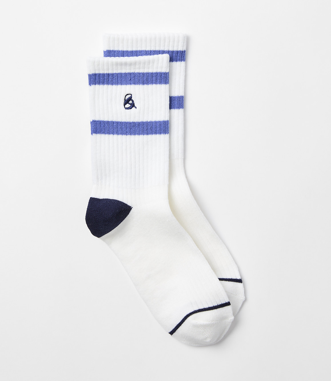 A pair of white crew socks with blue stripes and a navy toe and heel sit against a plain white background.