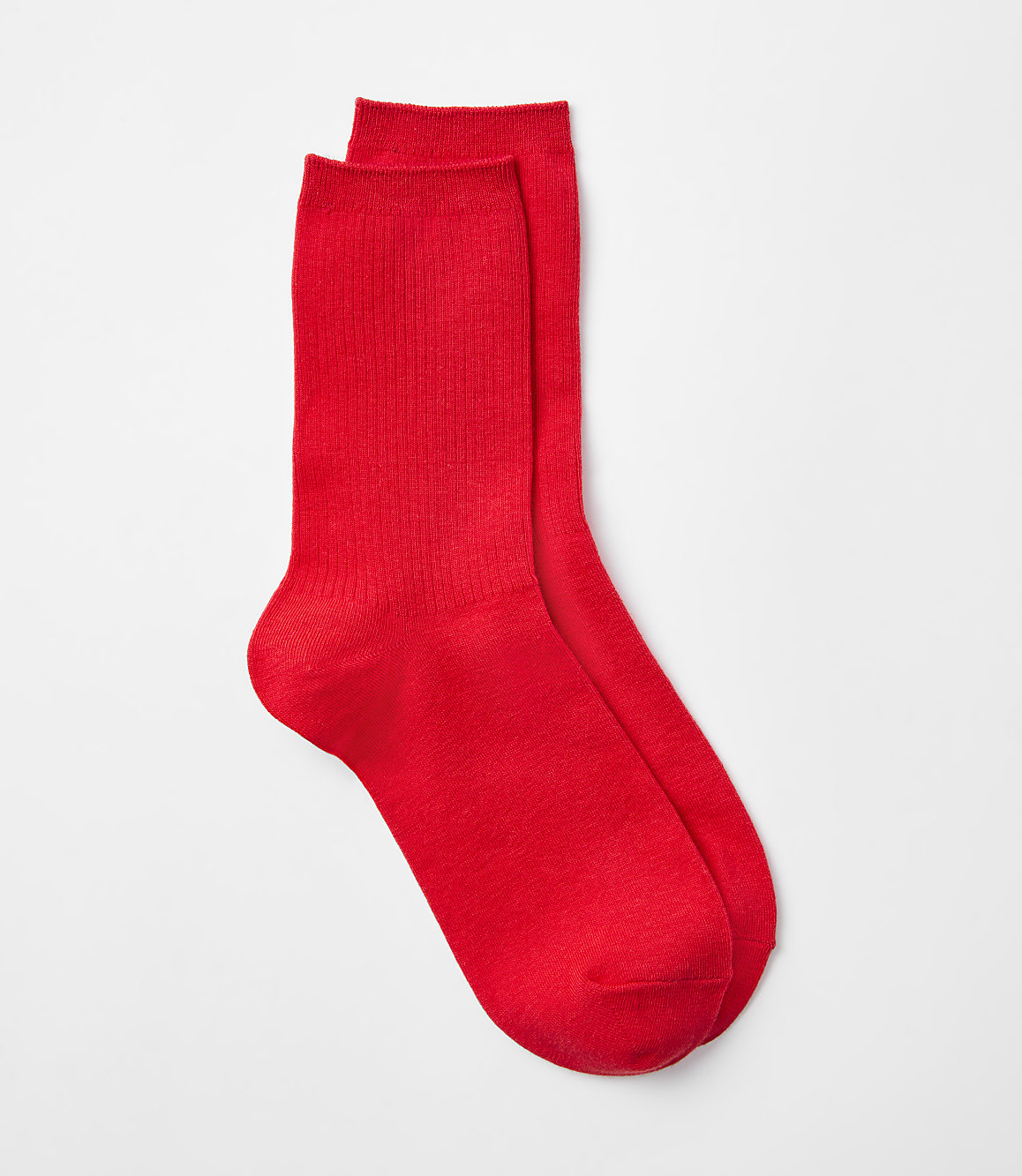 Two bright red socks are laid out against a plain white background.