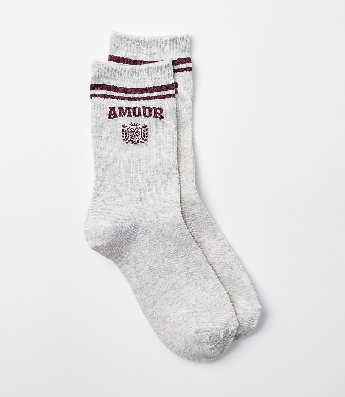 A pair of light gray socks with maroon stripes and "AMOUR" embroidered on them rests against a plain white background.