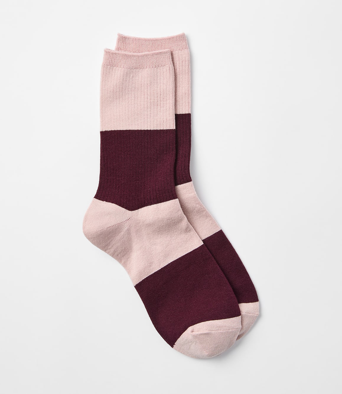 A pair of pink and burgundy striped socks rests on a plain white background.