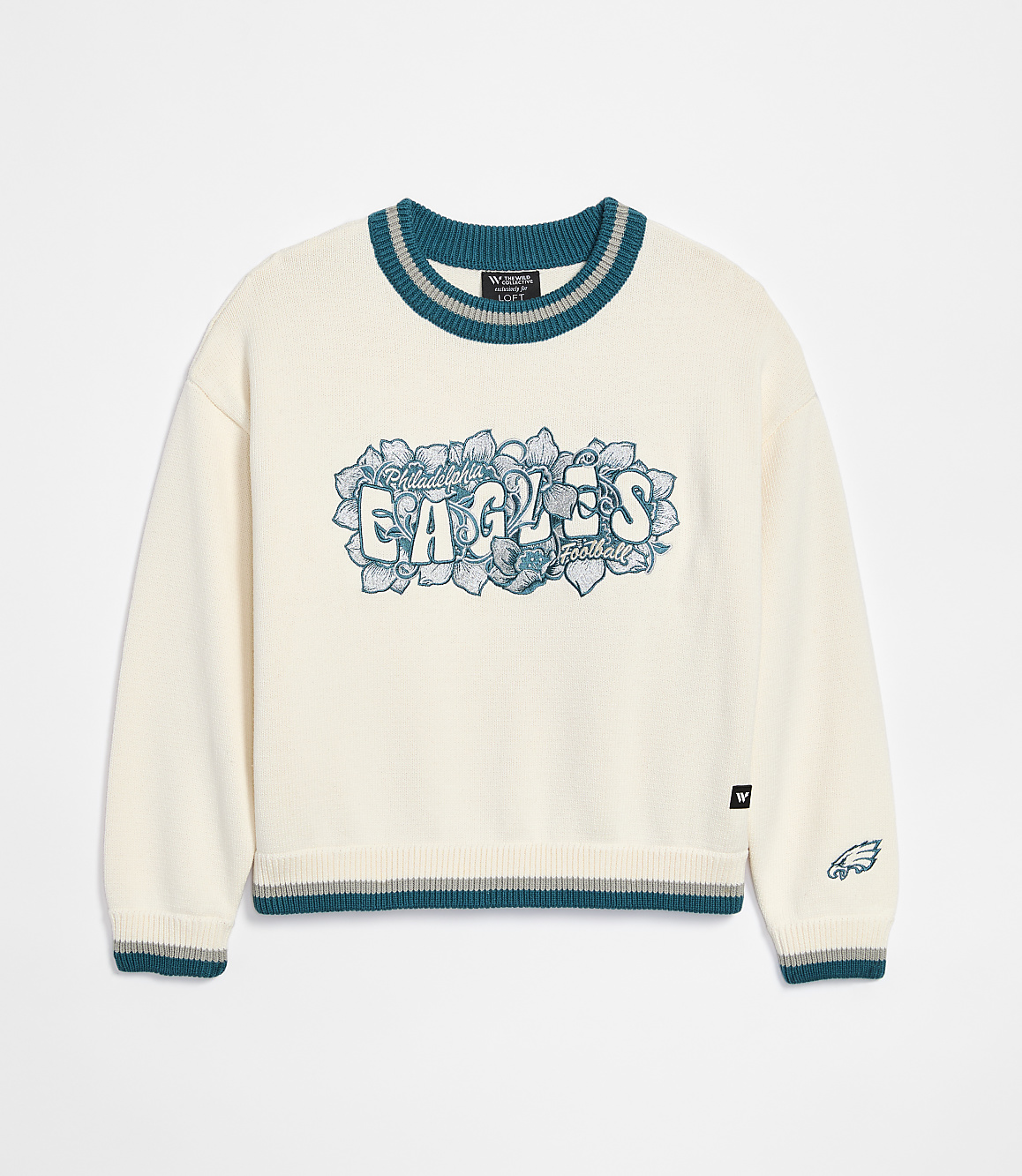 A cream-colored sweater with "Philadelphia Eagles" emblazoned across the chest in teal and gray lettering is displayed against a plain white background.