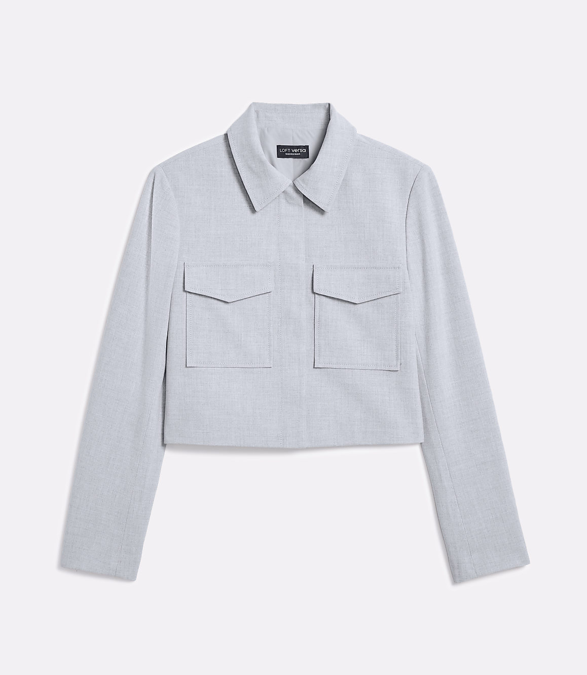 A light blue cropped jacket with two chest pockets is displayed against a plain white background.