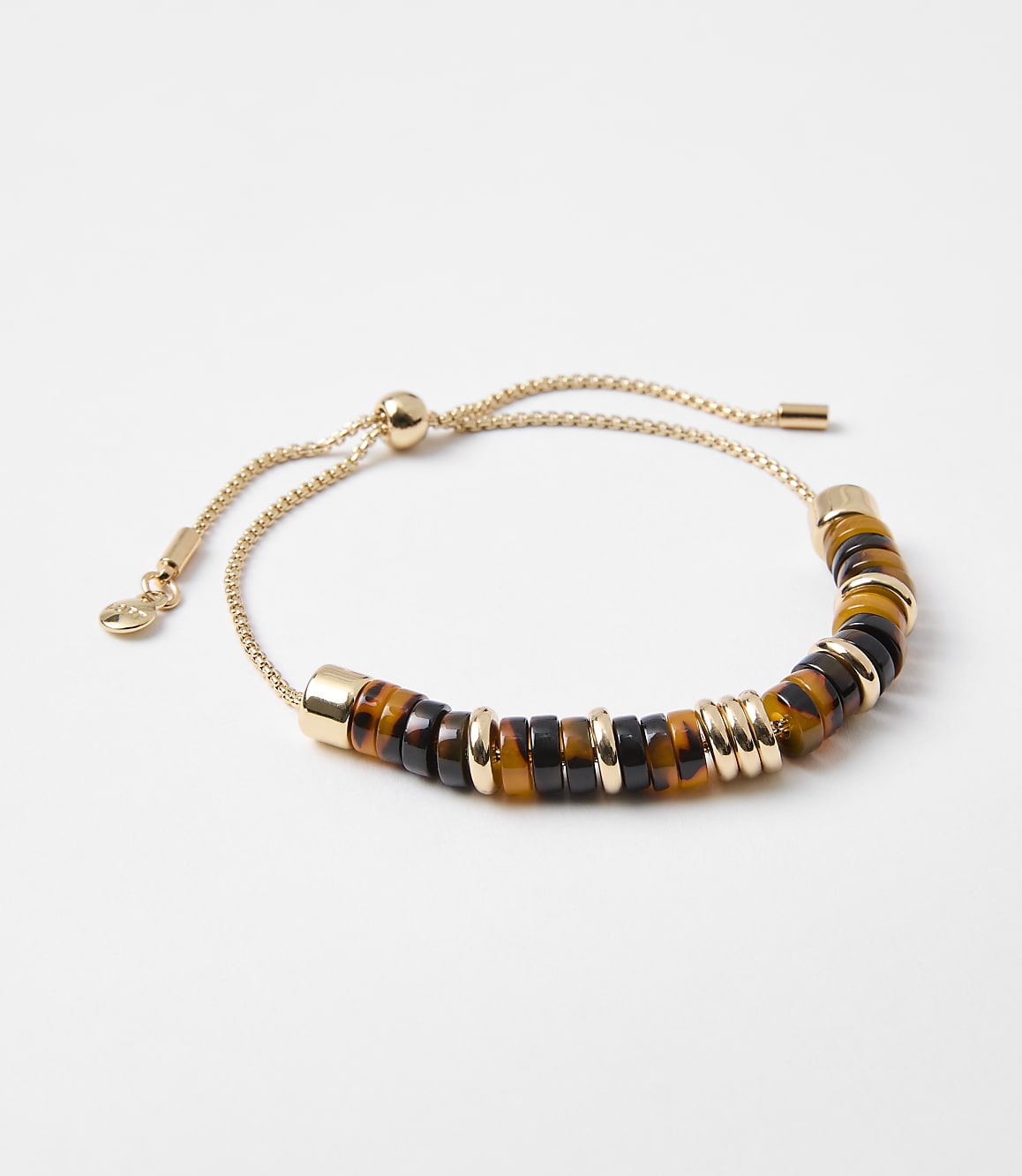 A gold chain bracelet with tiger's eye and black beads is displayed against a plain white background.