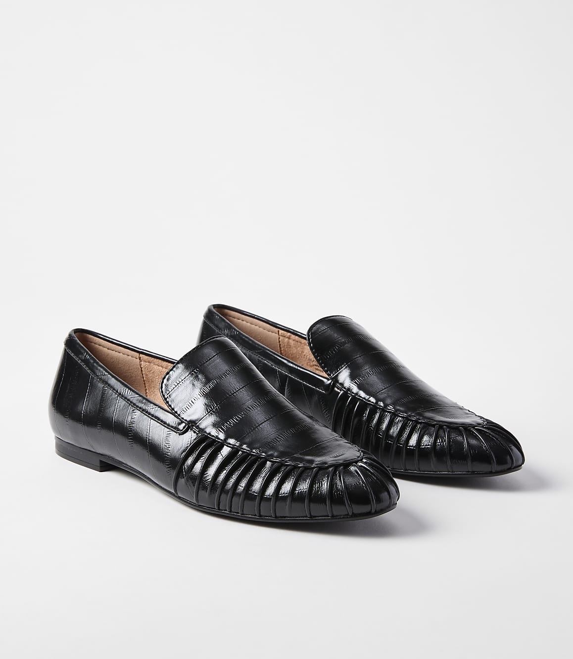 A pair of black, croc-embossed loafers with pleated detailing on the vamp rest on a plain white background.