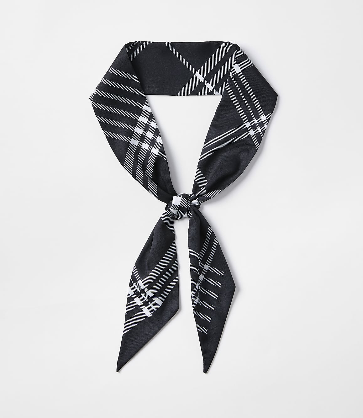 A black and white plaid scarf is tied in a knot in the foreground against a plain white background.