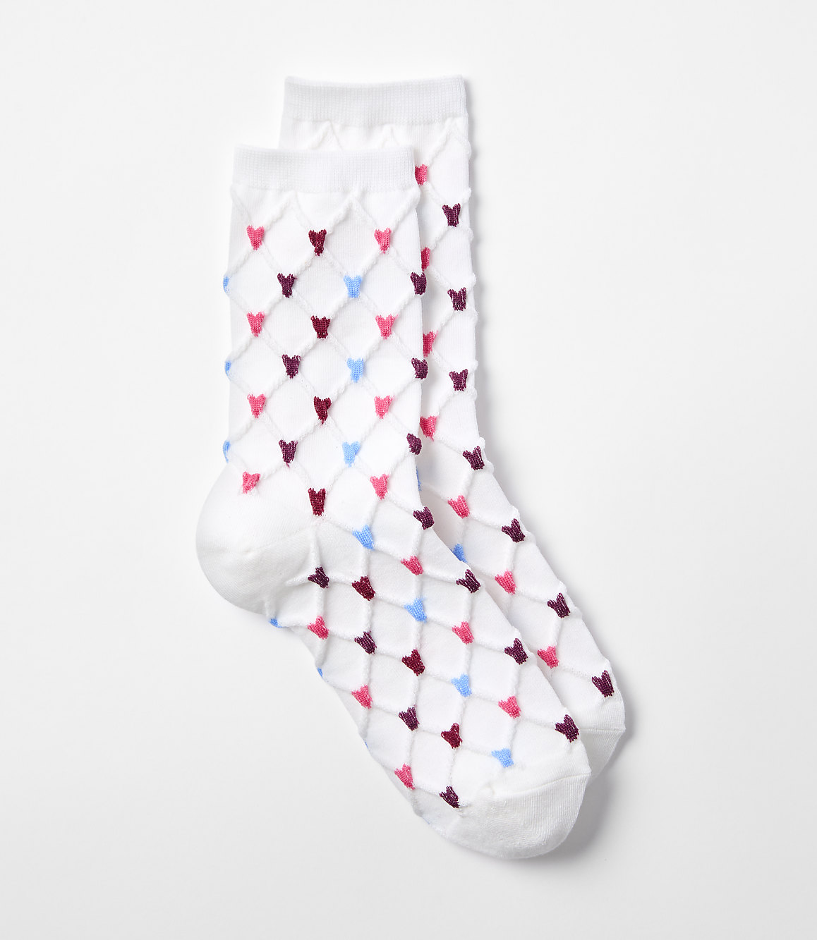 A pair of white socks with a diamond pattern of pink, blue, and maroon hearts are laid out on a plain white background.