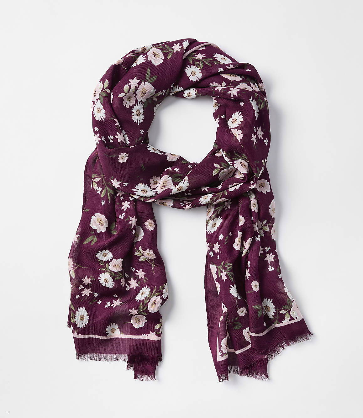 A burgundy floral scarf with frayed edges is laid out against a plain white background.