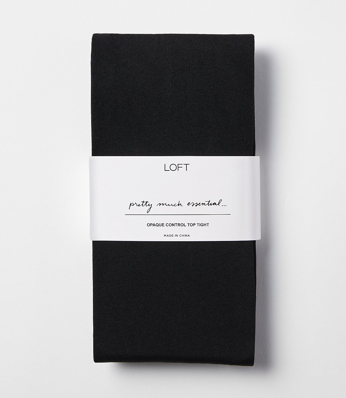 A pair of black opaque control top tights is neatly folded with a white band around the middle, set against a plain white background.