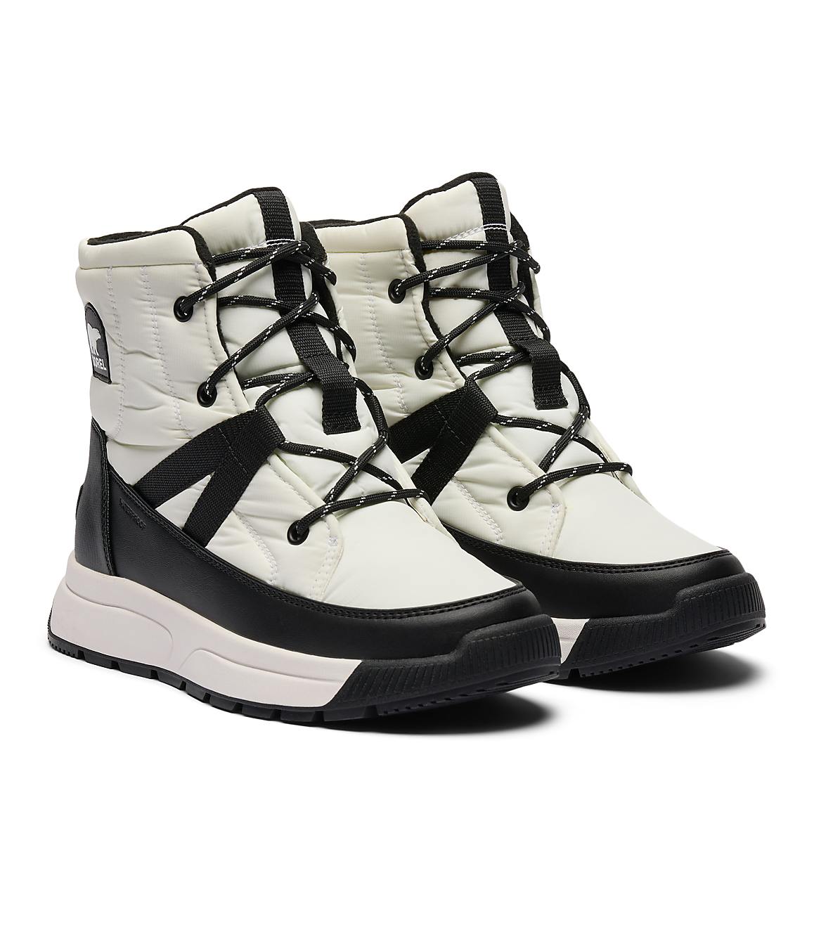 A pair of white and black quilted winter boots with black laces are displayed against a plain white background.