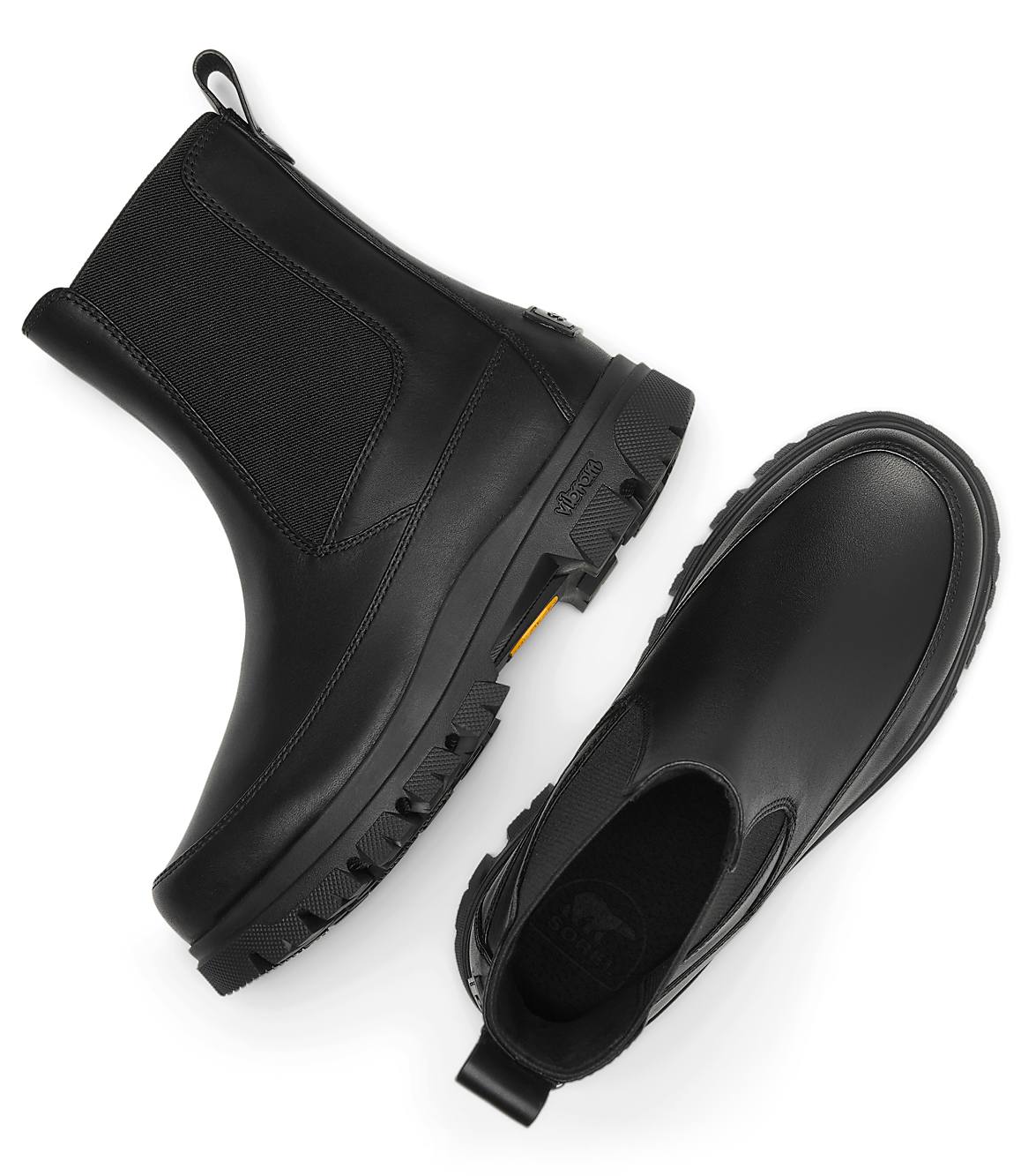 A pair of black leather Chelsea boots with thick soles are laid out on a plain white background.