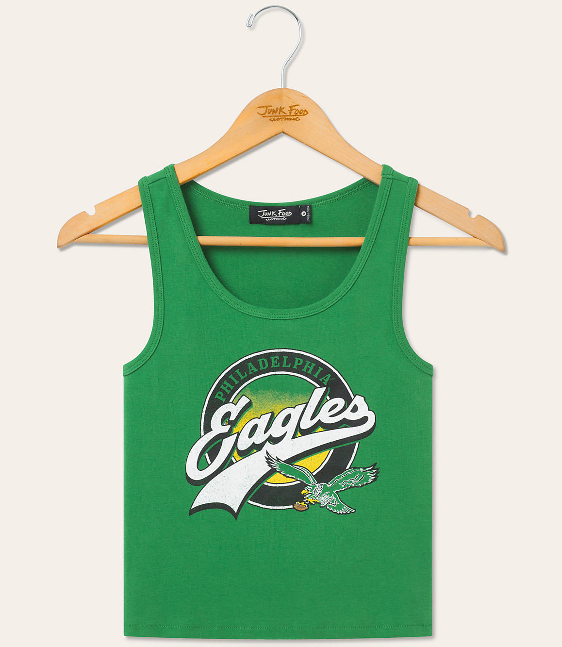 A green Philadelphia Eagles tank top hangs on a wooden hanger against a plain, light-colored background.