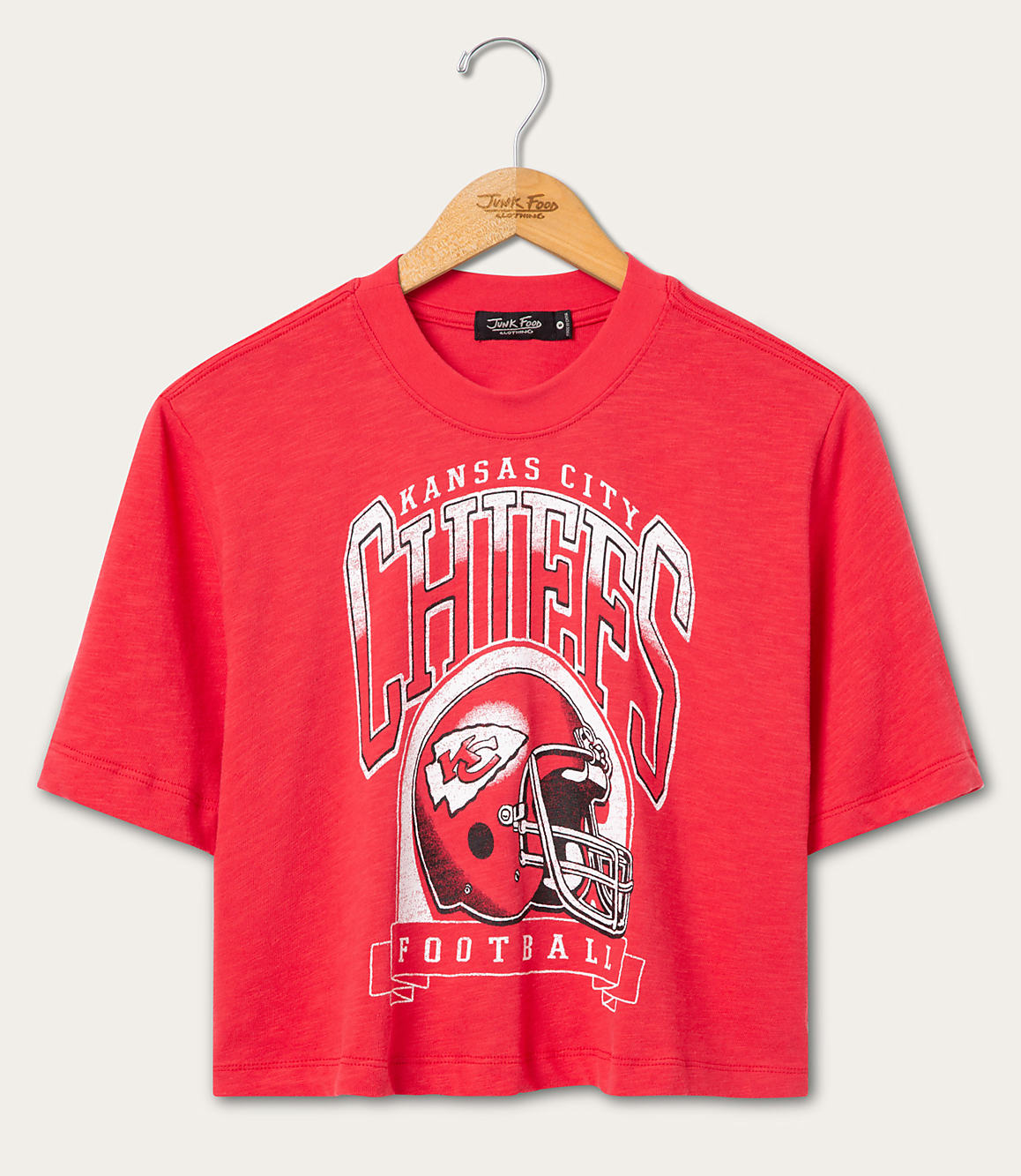 A red Kansas City Chiefs football t-shirt hangs on a wooden hanger against a plain white background.