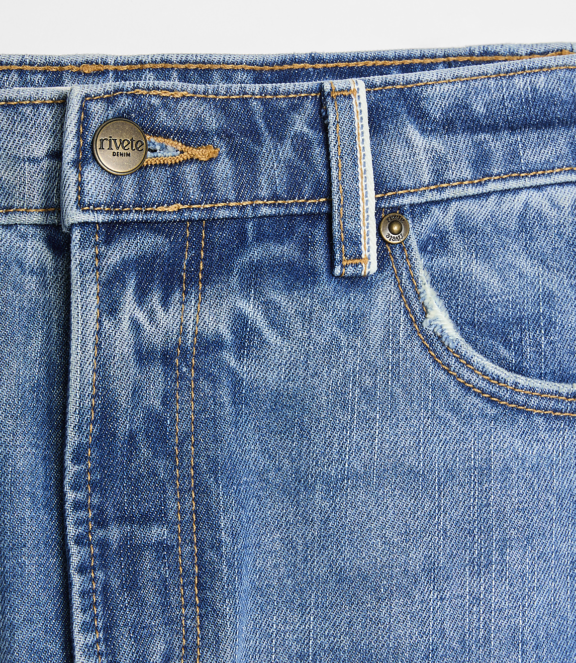 A close-up of blue denim jeans with a metal button and pocket in the foreground, set against a plain white background.