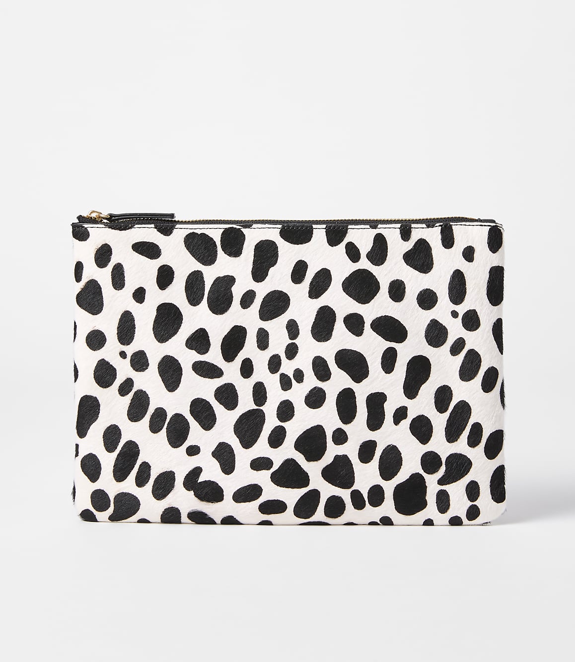 A black and white spotted clutch rests on a plain white background.