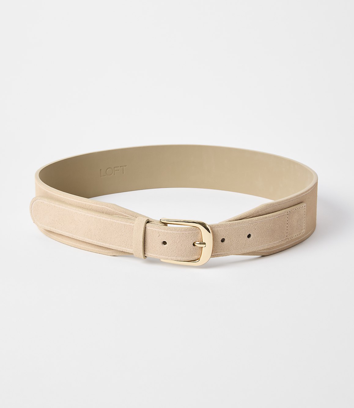 A light tan suede belt with a gold buckle lies on a plain white background.