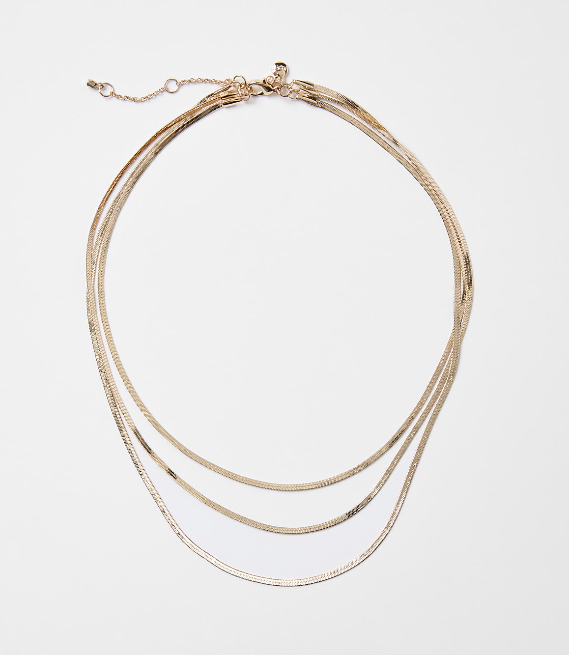 A delicate rose gold layered necklace with a white background.