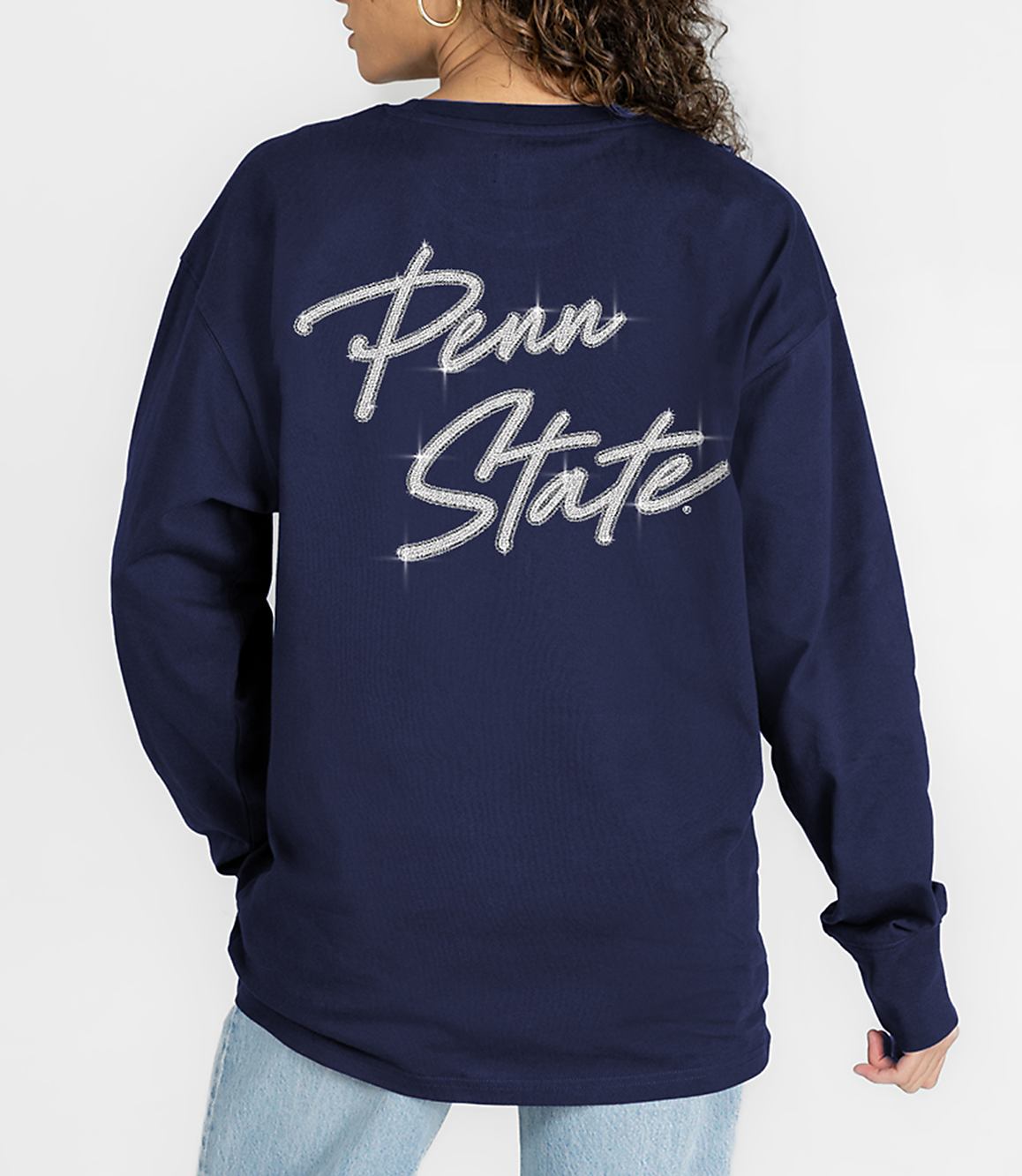A person in a navy blue long-sleeved shirt with "Penn State" written in rhinestones stands against a plain white background.