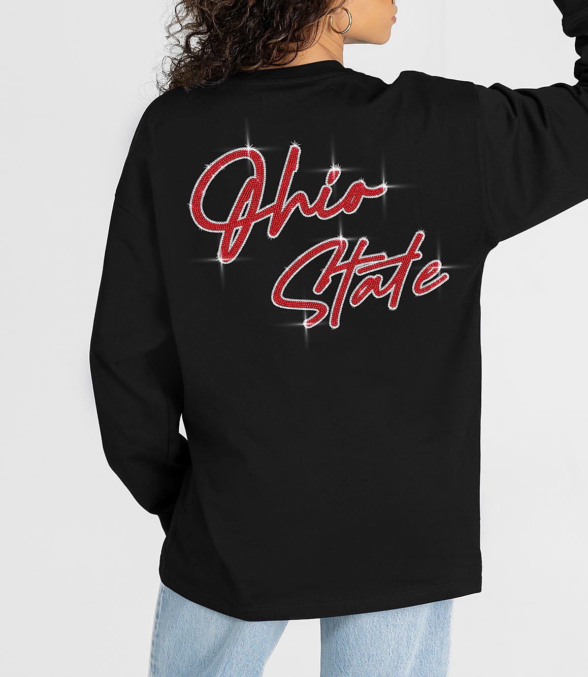 A person wearing a black long-sleeved shirt with "Ohio State" in sparkly red lettering on the back is shown against a plain background.