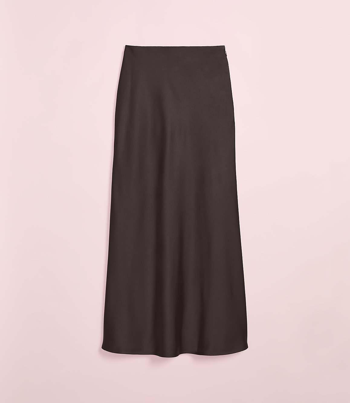 A dark brown, floor-length skirt hangs against a soft pink background.