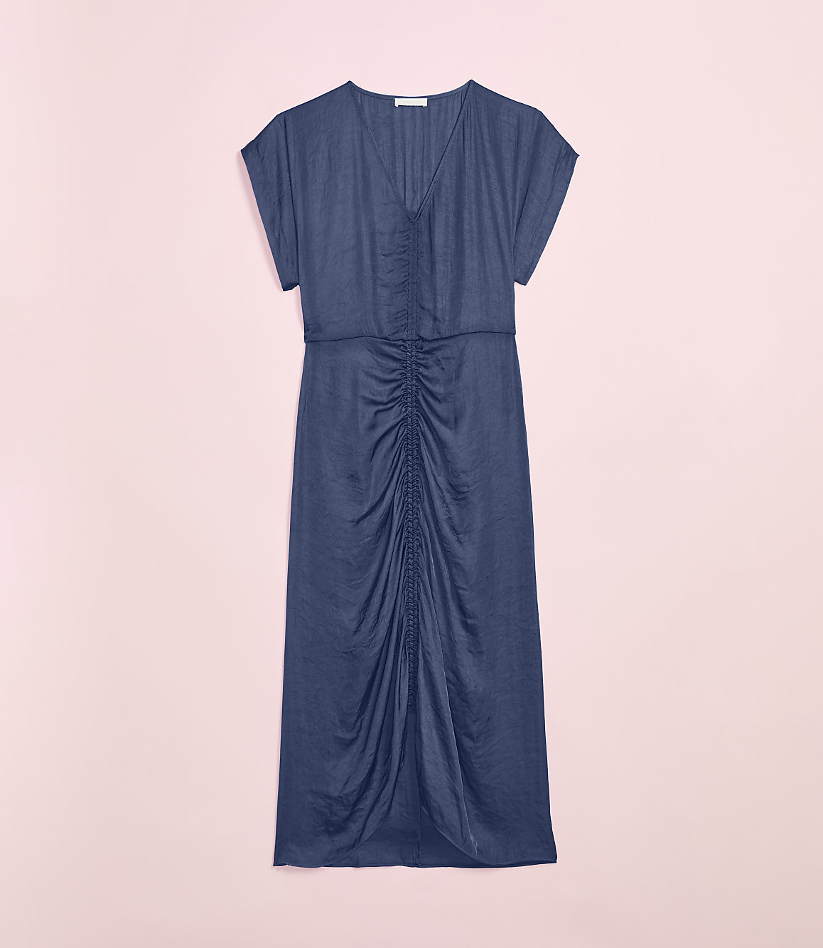 A navy blue ruched midi dress is laid flat against a soft pink background.