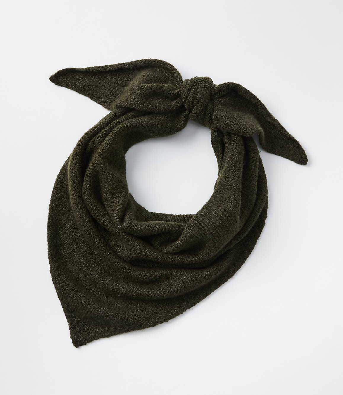 A dark green knitted scarf is tied in a bow in the foreground against a plain white background.