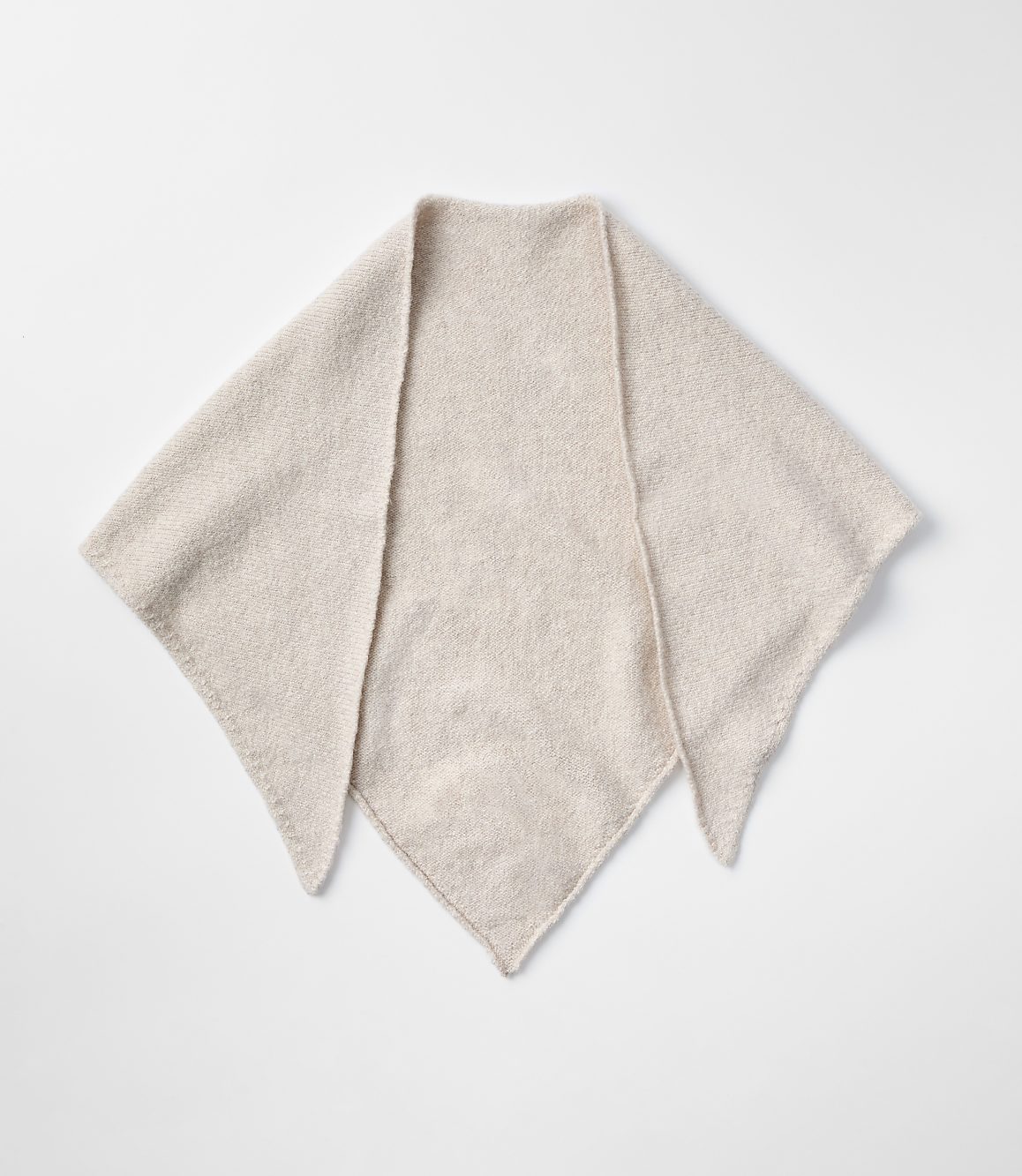 A light-colored, fuzzy triangular scarf lies flat against a plain white background.