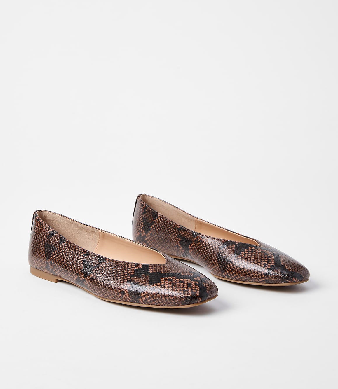 A pair of brown snakeskin ballet flats rests on a plain white background.
