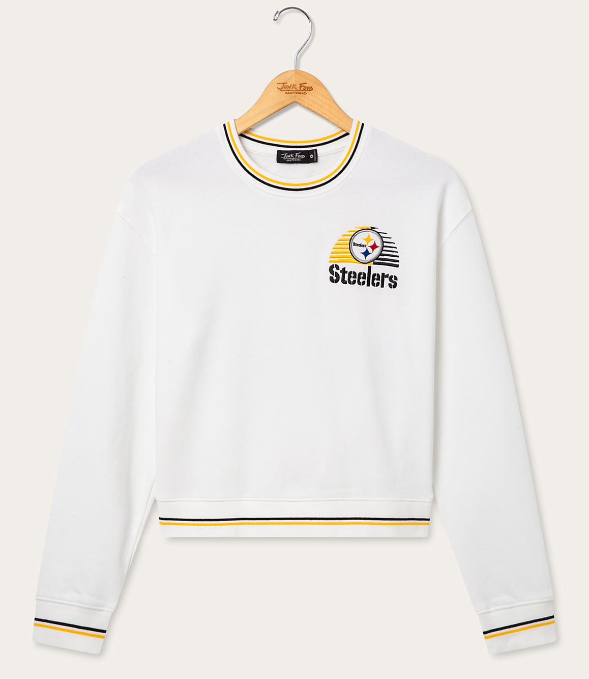 A white Pittsburgh Steelers sweatshirt with striped cuffs and neckline hangs on a wooden hanger against a plain white background.