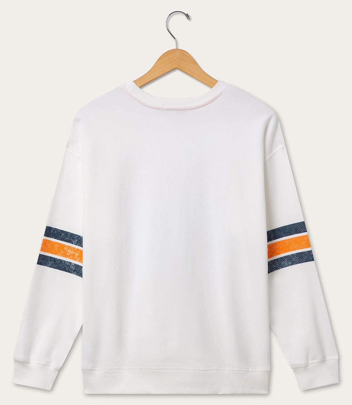 A white sweatshirt with orange and navy stripes on the sleeves hangs on a wooden hanger against a plain white background.