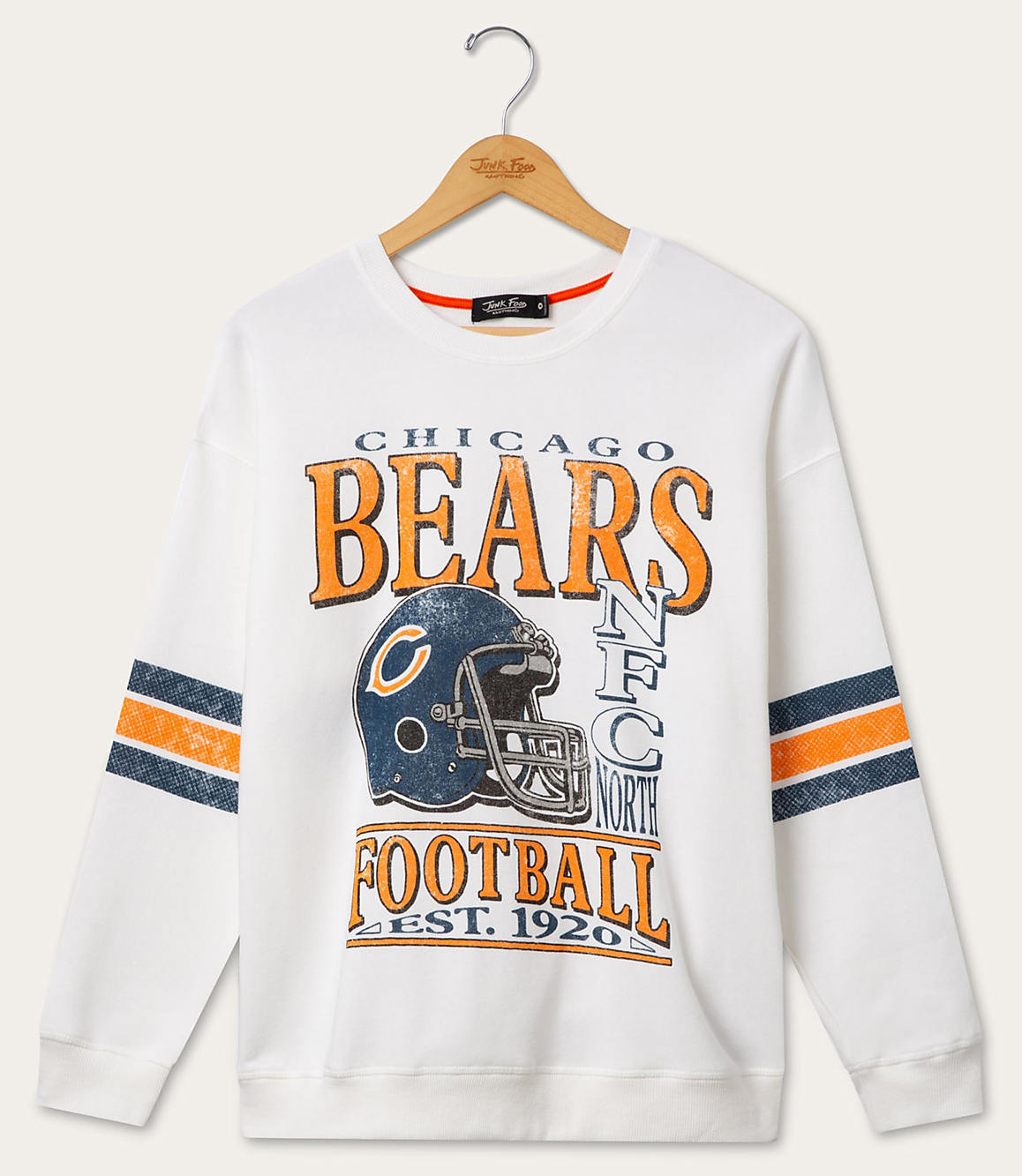 A white Chicago Bears sweatshirt with striped sleeves hangs on a wooden hanger against a plain white background.